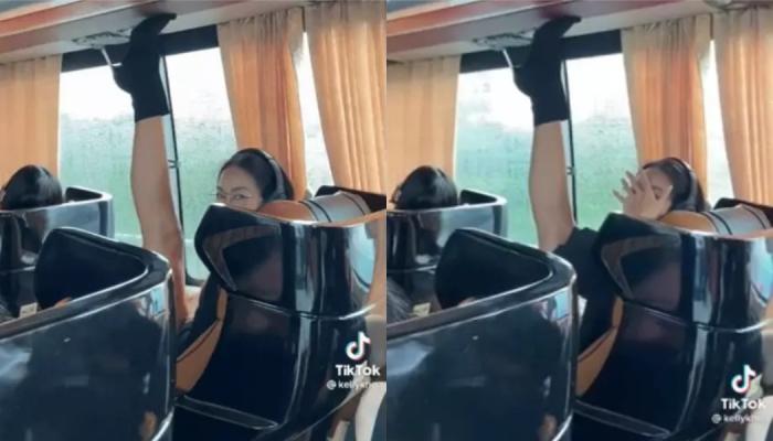 Một thí sinh Hoa hậu Hoàn Vũ ngồi dạng xoạc chân, chạm đế giày lên trần xe bus